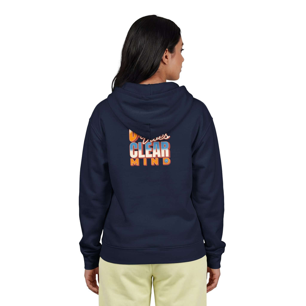 A woman viewed from the back wearing a navy blue hoodie with a colorful graphic on the back that reads 'Minnesota CLEAR MIND' in orange, white, and blue, paired with light yellow pants against a plain white background. Shop online Comfortable Chill Vibes Clear Mind Zip Hoodie Casual Wear for soft, everyday comfort, relaxed style, and an effortlessly calm look. Elevate your off-duty wardrobe with the Comfortable Chill Vibes Clear Mind Zip Hoodie—made for warmth, ease, and relaxed moments.