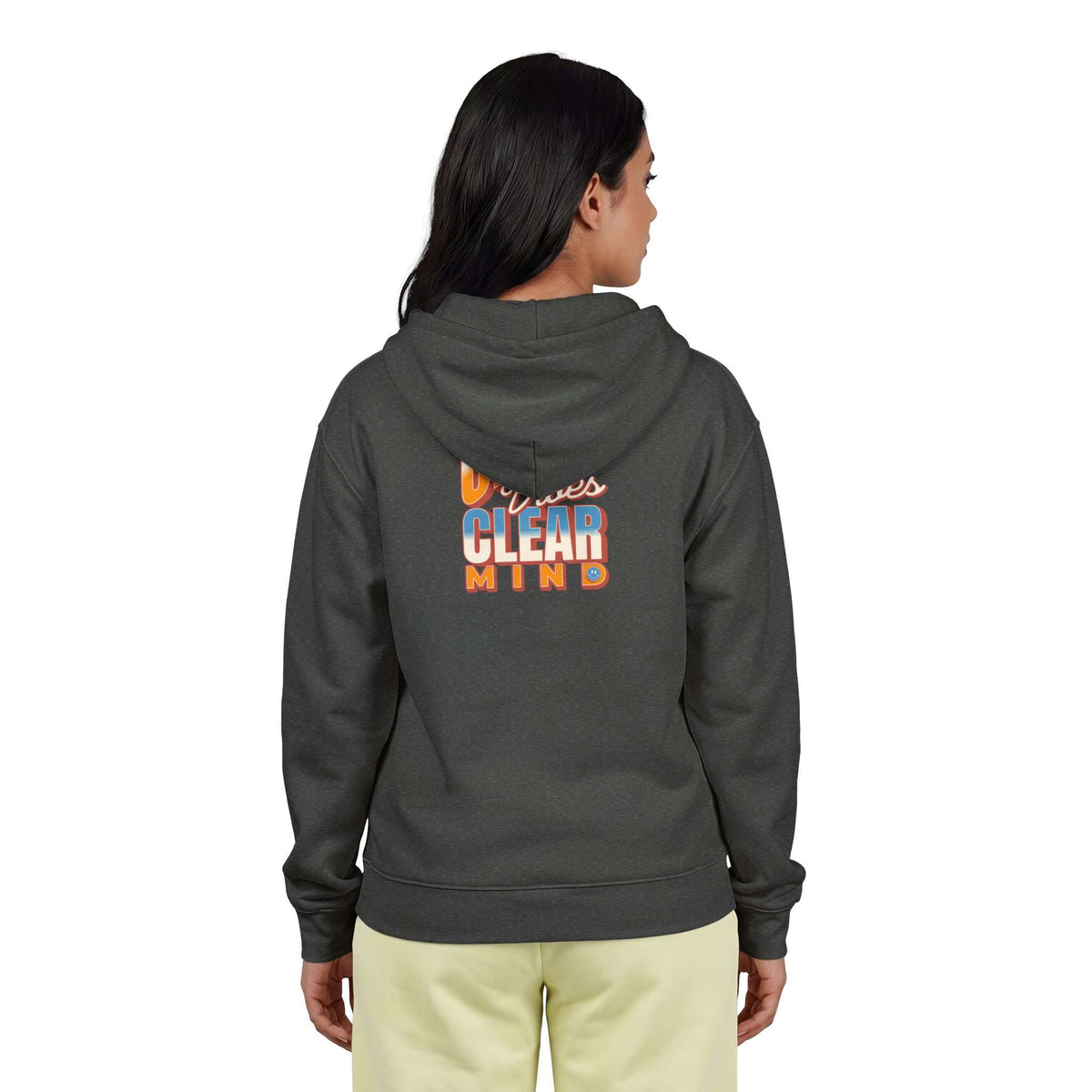 A woman viewed from the back wearing a dark charcoal gray hoodie with a colorful graphic on the back that reads 'Diversity's CLEAR MIND' in orange, blue, and white. She is also wearing light yellow pants against a plain white background. Shop online Comfortable Chill Vibes Clear Mind Zip Hoodie Casual Wear for soft, everyday comfort, relaxed style, and an effortlessly calm look. Elevate your off-duty wardrobe with the Comfortable Chill Vibes Clear Mind Zip Hoodie—made for warmth, ease, and relaxed moments.